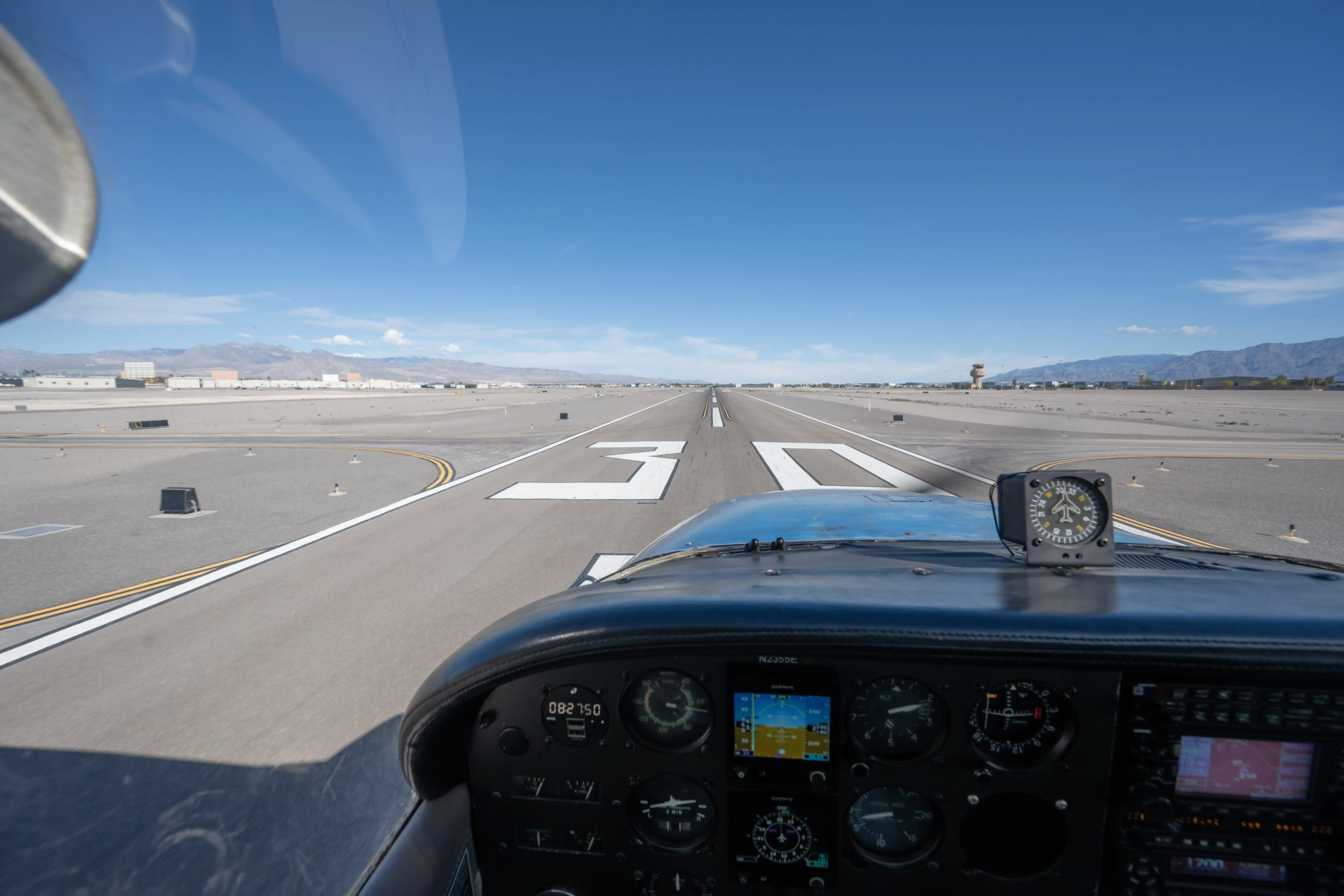 View from inside cockpit of airplane taking off on a runway